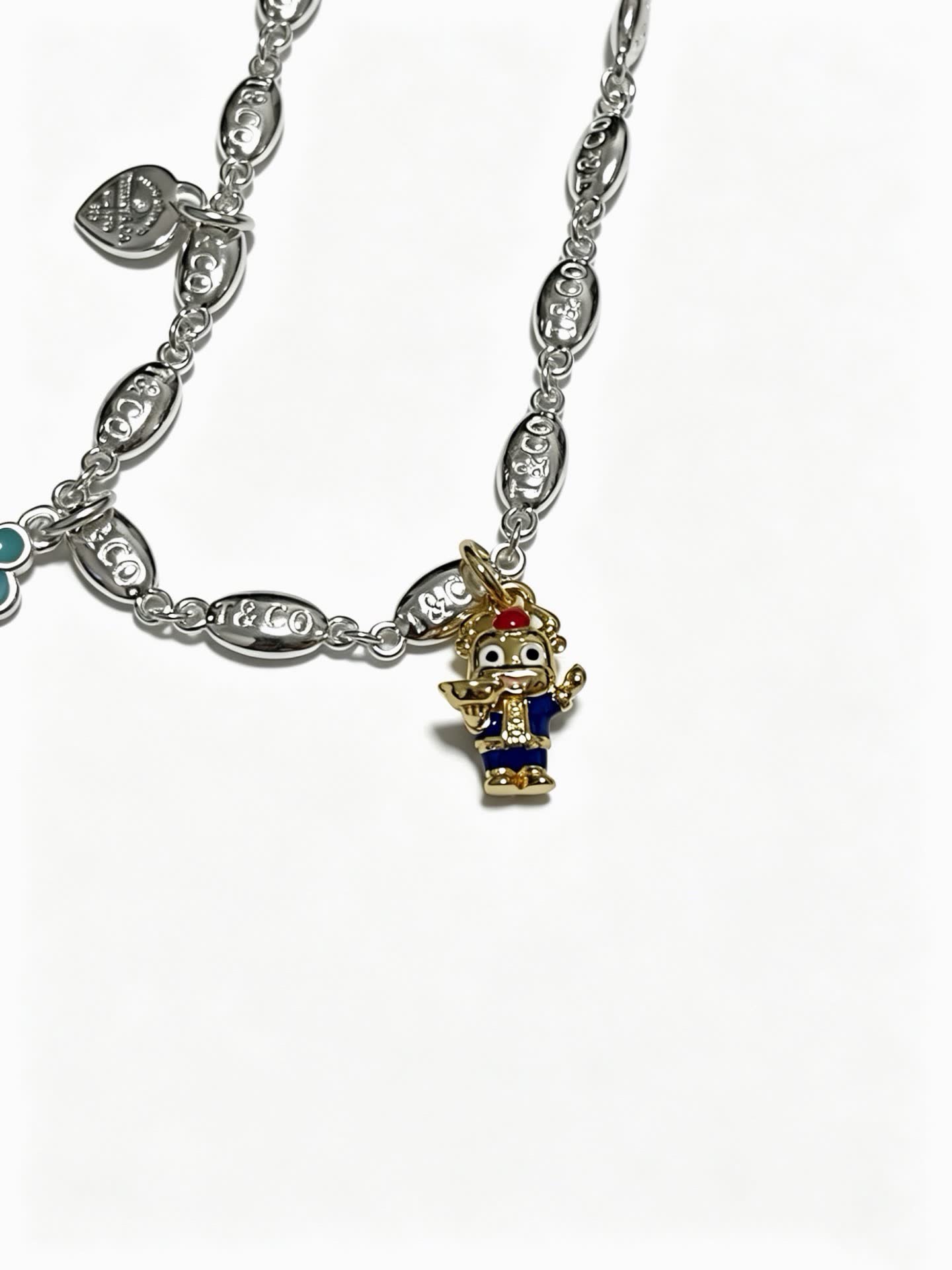 Tiffany & Co Silver Charm Bracelet with Key and Character Pendant